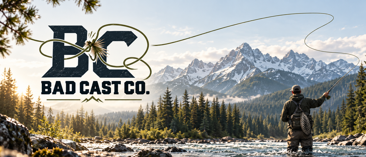 A fly fisherman stands in a mountain river with snowy peaks and pine trees in the background, casting a line. The Bad Cast Co.
